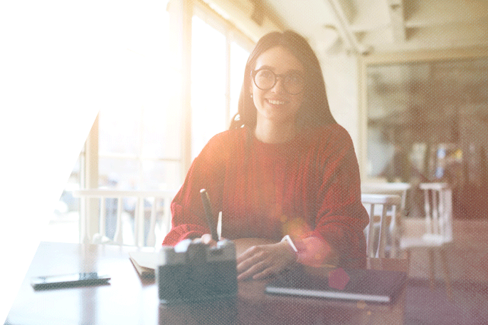 Woman sitting at a table smiling