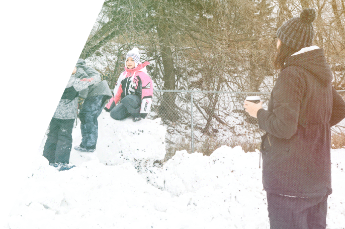 ECE student watching children play on a snow hill