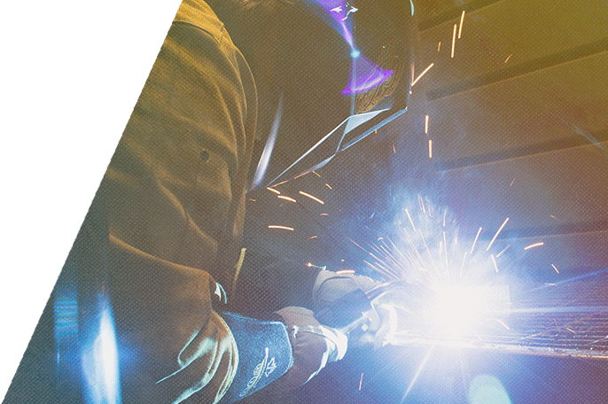 A welding student welds.