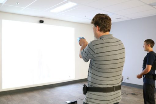 Two men facing a policing simulation scenario