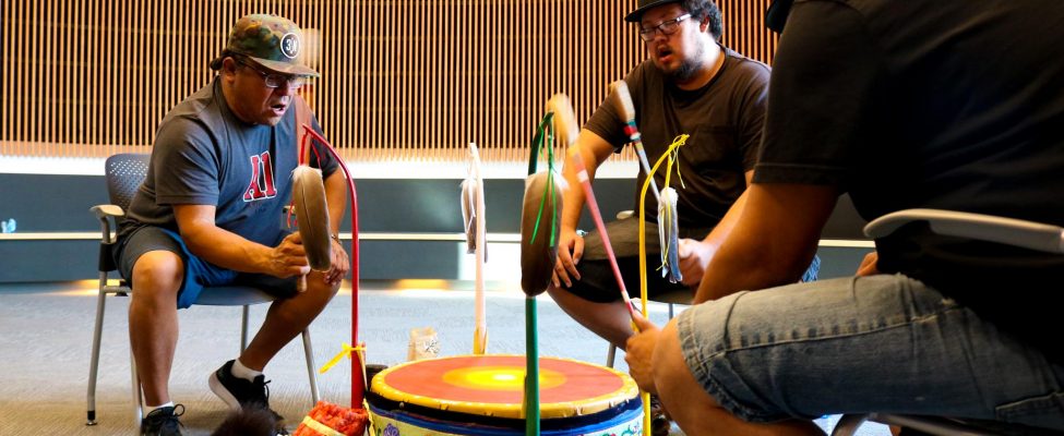 Men seated around a traditional drum