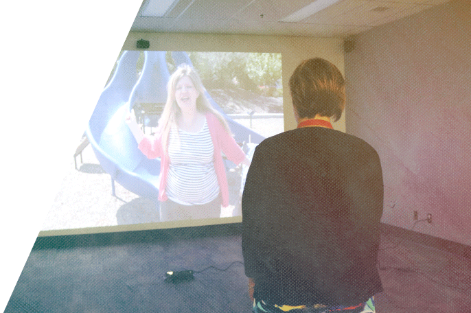 Woman facing a simulation screen in SGEI's simulation lab