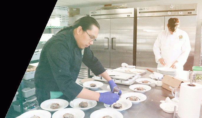 A student prepares dishes in the Culinary course