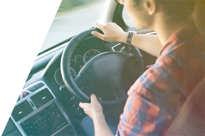 View of man driving a car from inside of the car