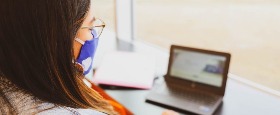 A focused student studying on laptop