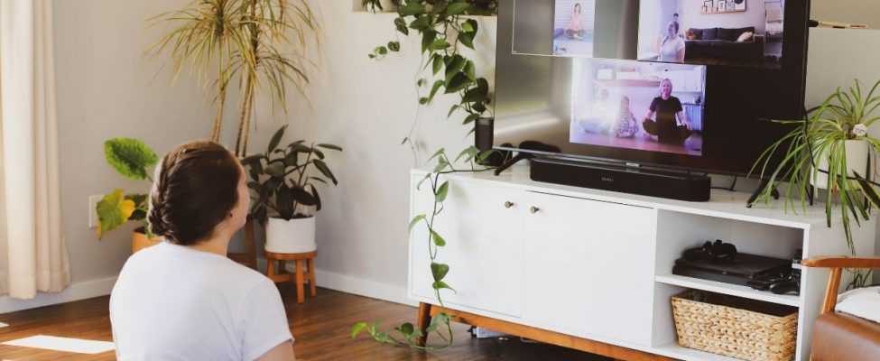 A person sitting comfortably, watching television