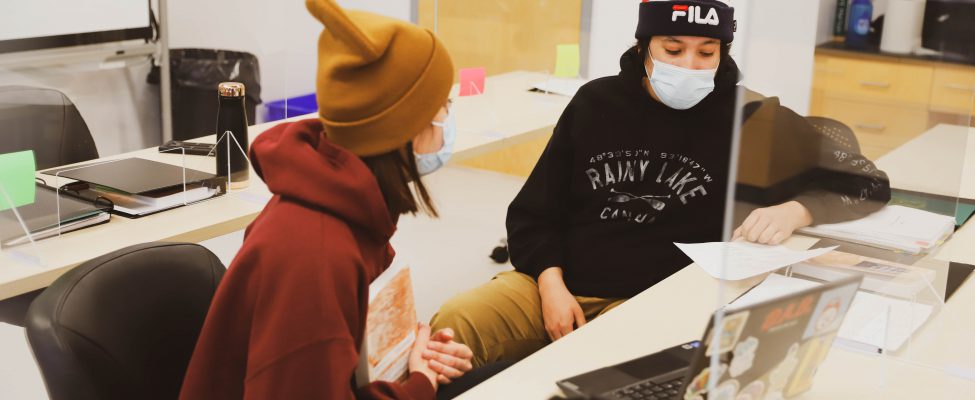 Two students sitting together, focused on their studies