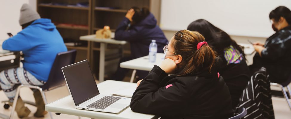 Female students focused on their laptops studying