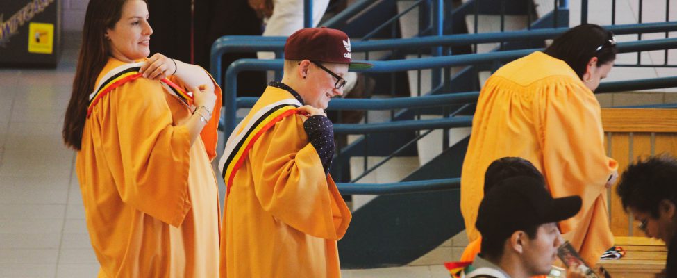 A group of graduates adorned in their graduation gowns in celebration of their academic achievements