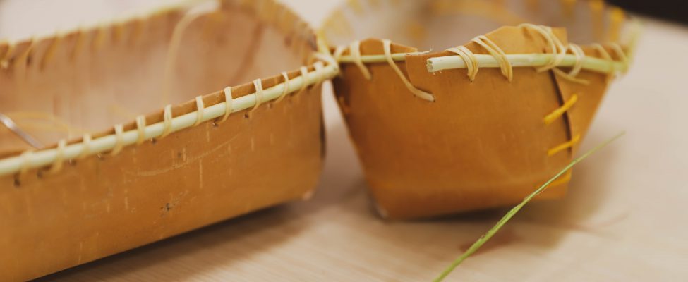 Two birch bark baskets showcasing traditional craftmanship