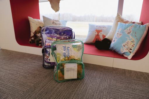 Set of two clear backpacks filled with children's activities