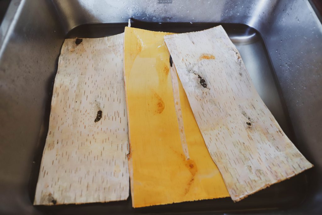 Birch bark soaking in water in a sink