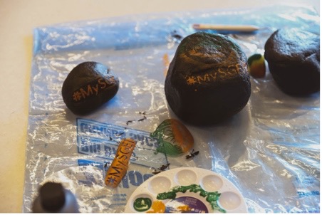 A group of rocks with different designs painted on them