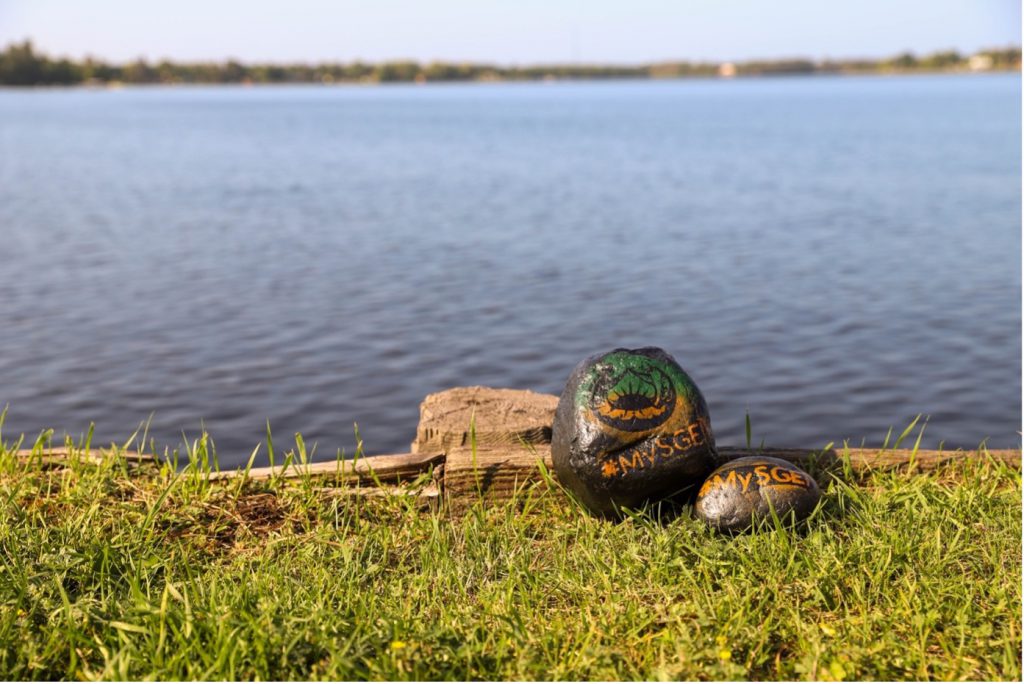 A couple rocks set against the serene backdrop of a picturesque lake