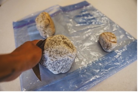 Collection of rocks being smoothed with sandpaper