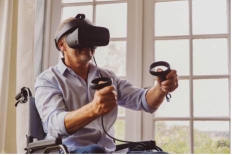 Disabled man using a virtual reality (VR) headset to explore the digital environment