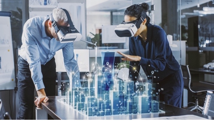 Two architects using virtual reality (VR) headsets to plan out a construction project