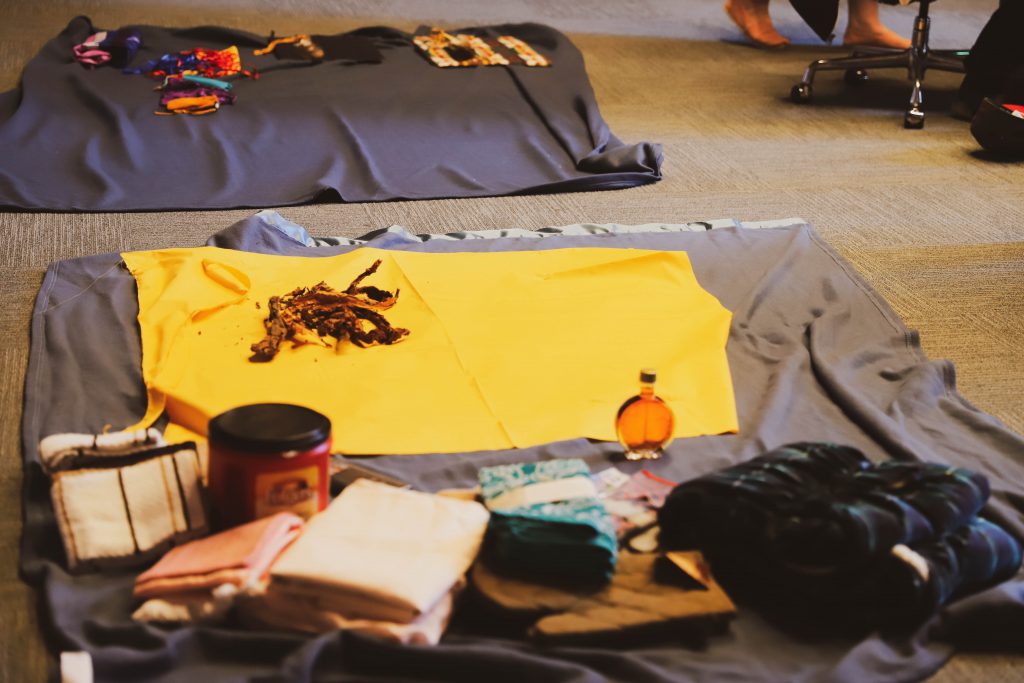 Ceremonial scene capturing tobacco placed beside a spread of items being feasted.