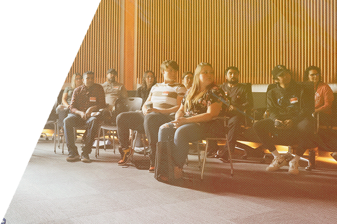 A group of SGEI students listen during their orientation.