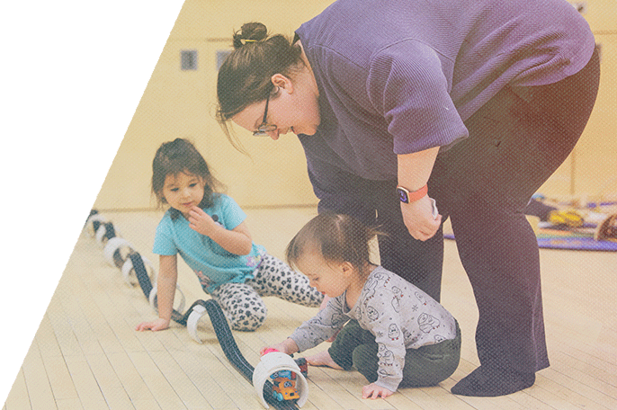 An ECE student plays with children.