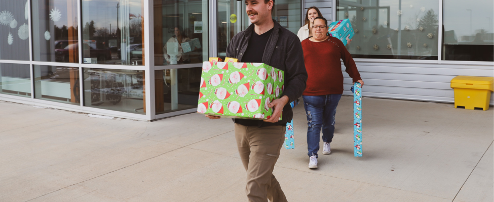 SGEI employees carry gifts.