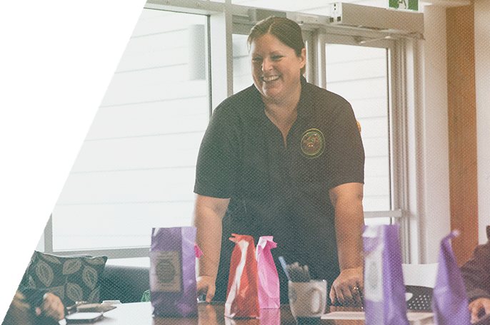 An SGEI employee laughs with a student.