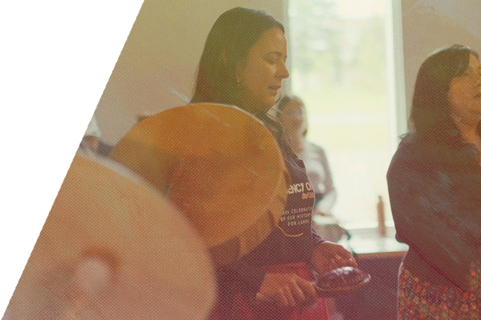 Anishinaabemodaa director Shannon Chapman sings during ceremony.