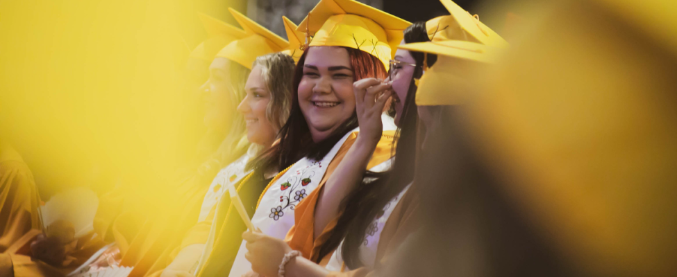 An SGEI grad smiles during the ceremony.