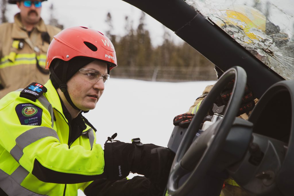 Paramedic student Ian Davidson practices a vehicle extrication.