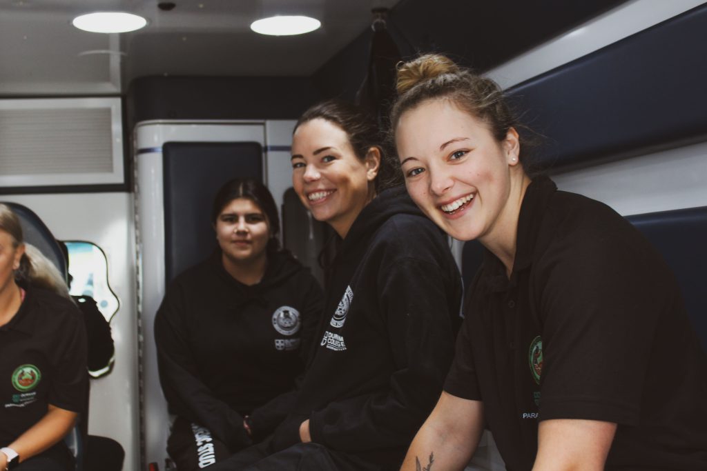 Paramedic student Nadia Treftlin-Webb smiles in the back of SGEI's training ambulance.
