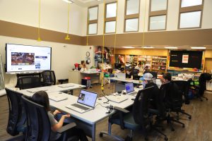 Group of kids sitting at laptops in the Kenora Campus Makerspace