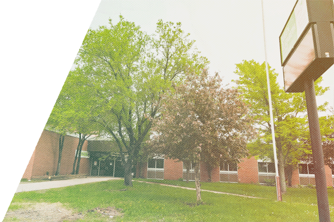 Image of SGEI's Sioux Lookout Campus in summer with trees in front