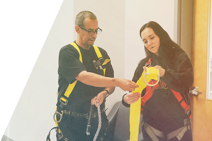 Woman and a man looking at a strap during Working at Heights training