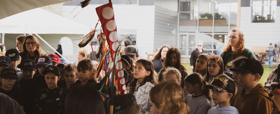 A student at SGEI's Fall Harvest event holds the grandmother staff.
